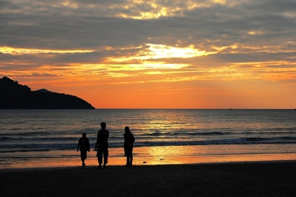 family affected by ME/CFS POTS walking on beach at sunset