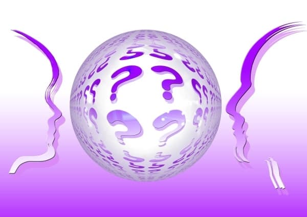 two heads facing a ball of questions marks